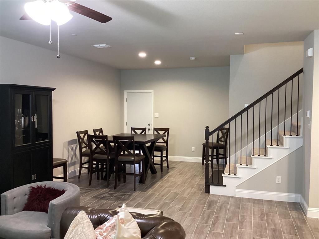 5984 Bursey Road Watauga, TX 76148 - Photo 8 of 21 Open-concept space featuring wood-finish flooring, recessed lighting, and a modern staircase with dark balusters and white risers