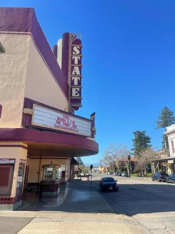 a roof deck with table and chairs