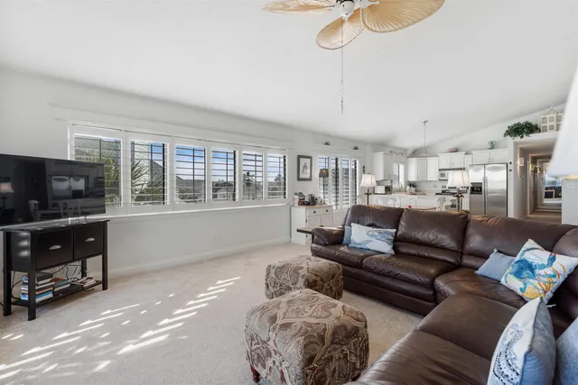 a living room with furniture and a painting on the wall