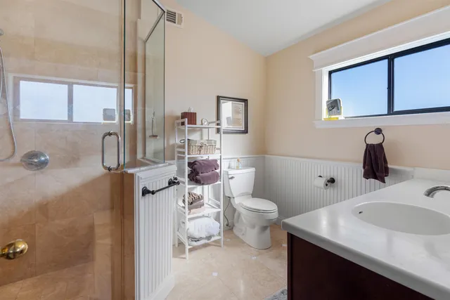 a bathroom with a toilet a sink and a mirror