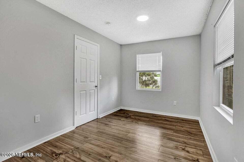 3645 Edison Avenue Jacksonville, FL 32254 - Photo 15 of 21 an empty room with wooden floor and windows