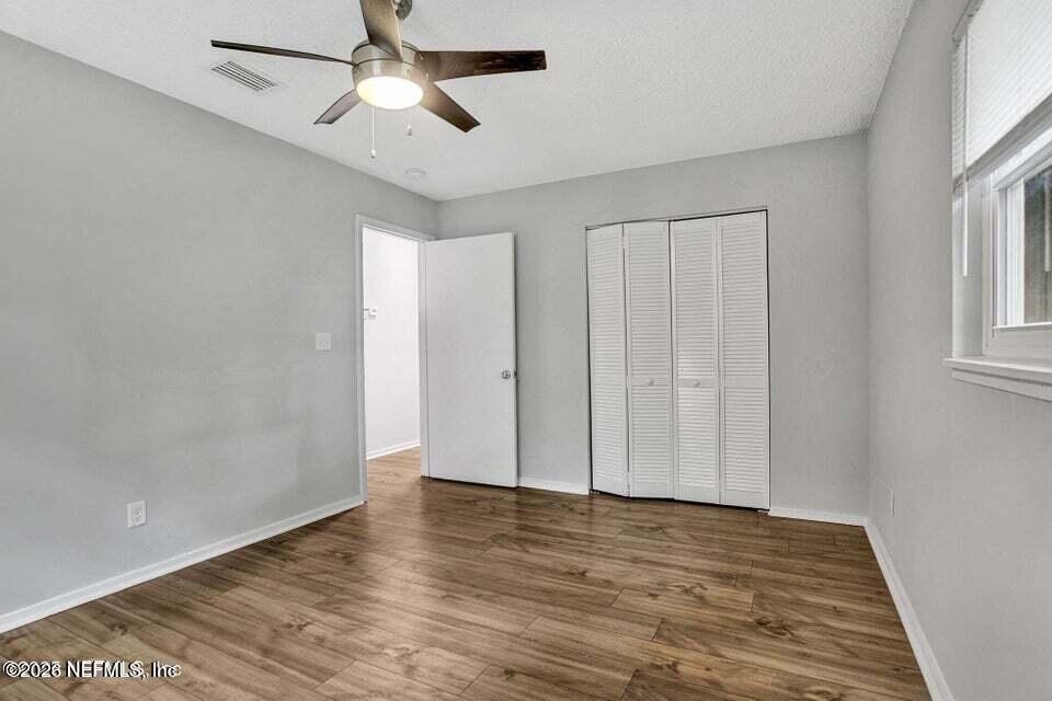 3645 Edison Avenue Jacksonville, FL 32254 - Photo 16 of 21 wooden floor in an empty room with a window