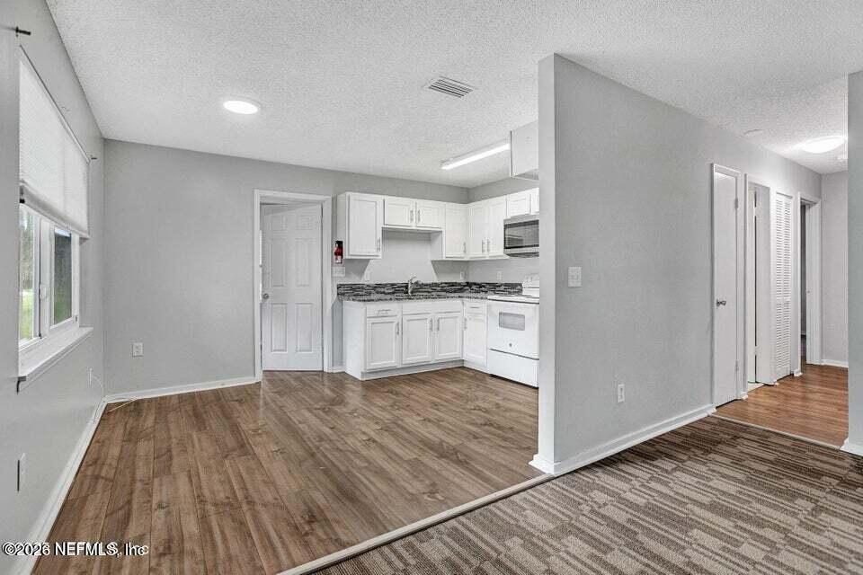 3645 Edison Avenue Jacksonville, FL 32254 - Photo 10 of 21 a kitchen with granite countertop a stove and a refrigerator