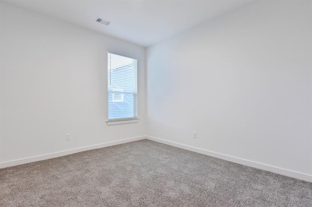 718 West Texas Street Denison, TX 75020 - Photo 10 of 22 an empty room with a window