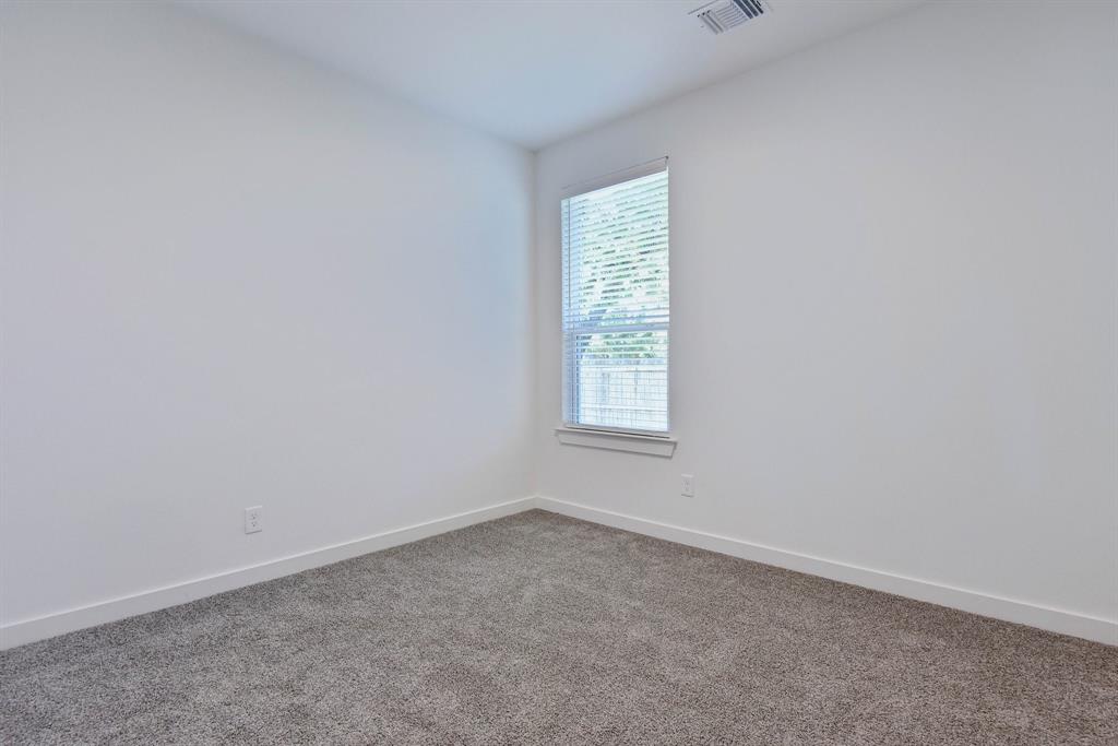 718 West Texas Street Denison, TX 75020 - Photo 13 of 22 an empty room with a window