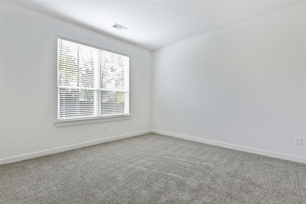 718 West Texas Street Denison, TX 75020 - Photo 15 of 22 an empty room with a window