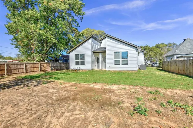 a view of a house with yard and a garden