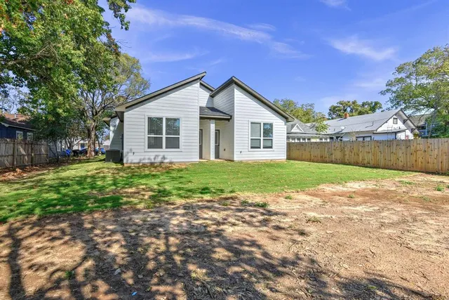 a view of backyard of house with green space
