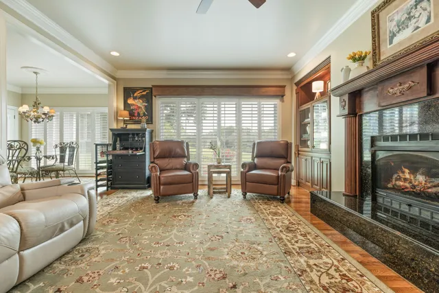 a kitchen with stainless steel appliances granite countertop a sink a stove and a wooden cabinets
