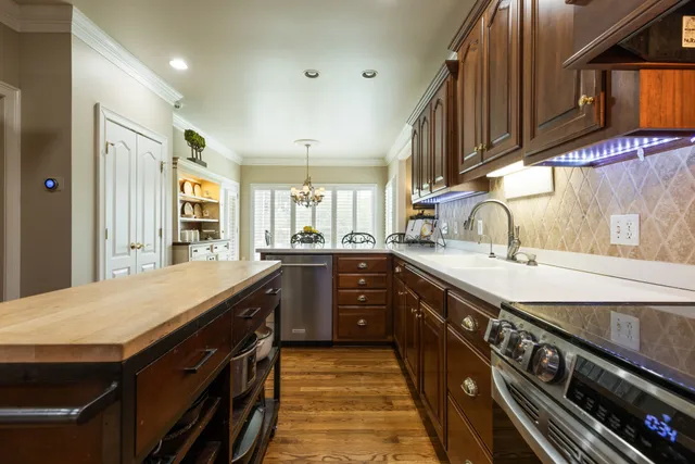 a yellow house with swimming pool in front of it