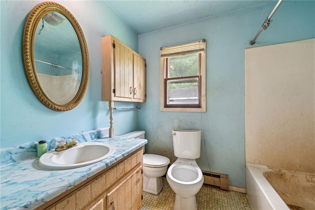 1298 Old State Road Apollo, PA 15613 - Photo 20 of 30 a bathroom with a granite countertop toilet a sink and a mirror