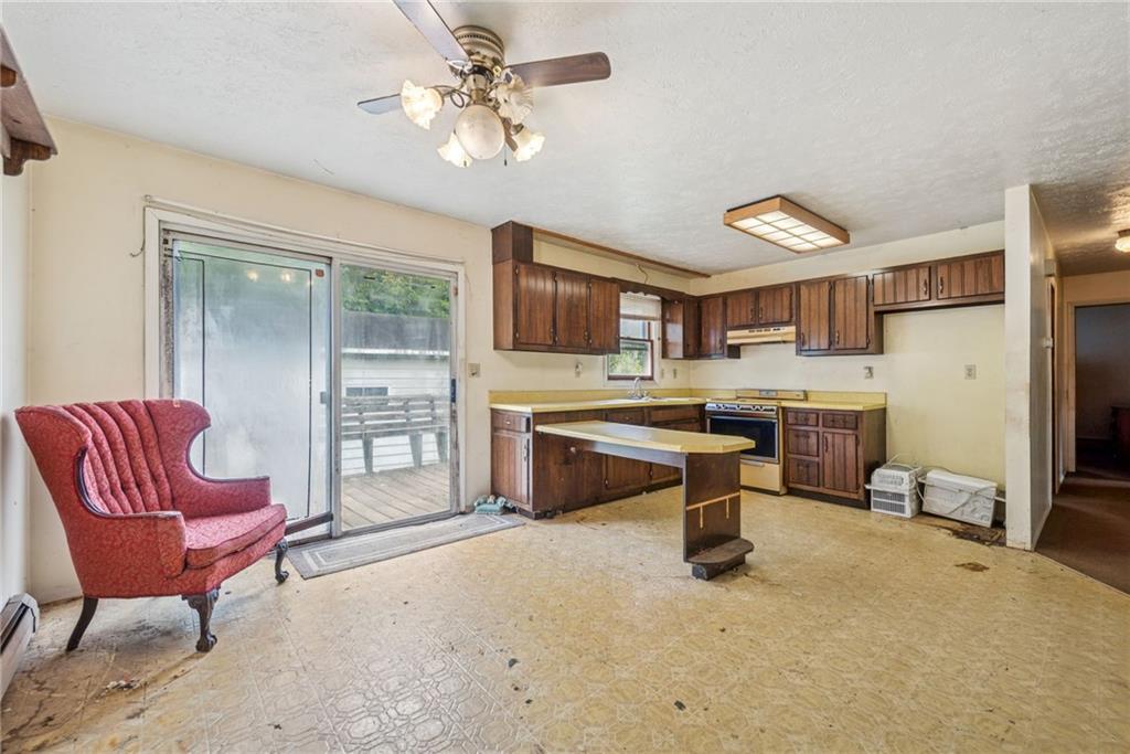 1298 Old State Road Apollo, PA 15613 - Photo 7 of 30 a living room with furniture a fireplace and a flat screen tv