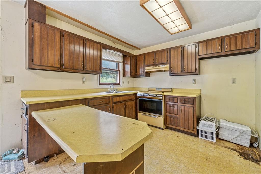 1298 Old State Road Apollo, PA 15613 - Photo 9 of 30 a kitchen with stainless steel appliances granite countertop a sink stove and refrigerator