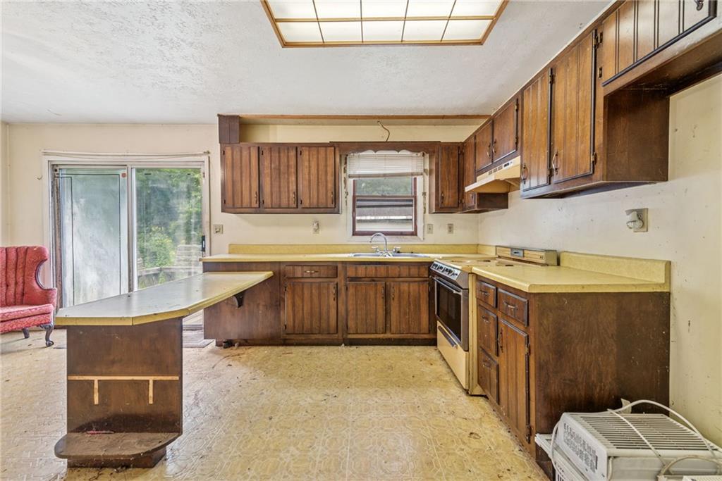 1298 Old State Road Apollo, PA 15613 - Photo 10 of 30 a kitchen with stainless steel appliances granite countertop a stove a sink and a microwave