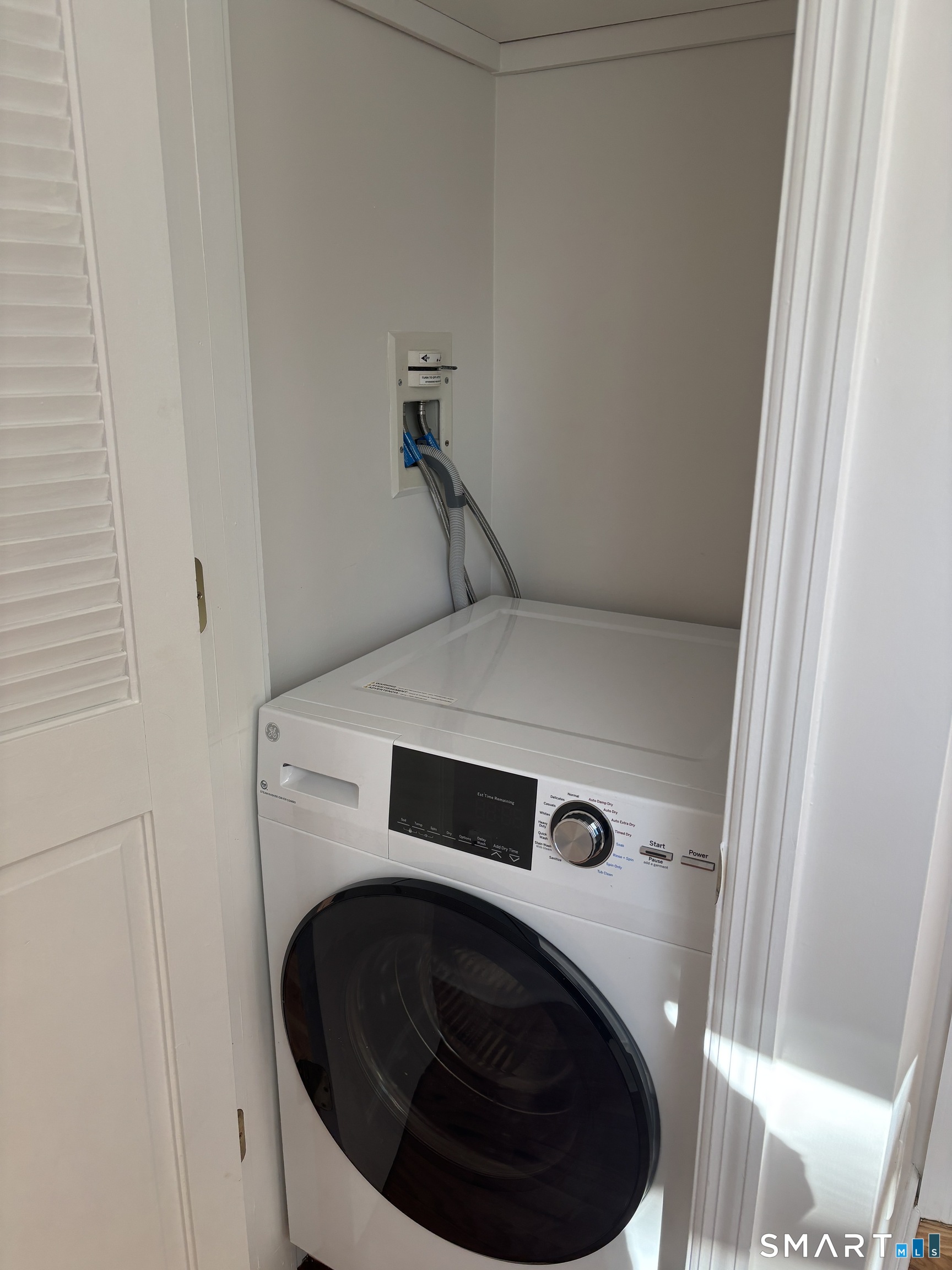 98 Ridgewood Avenue, Unit COTTAGE Stamford, CT 06907 - Photo 6 of 10 a utility room with dryer and washer