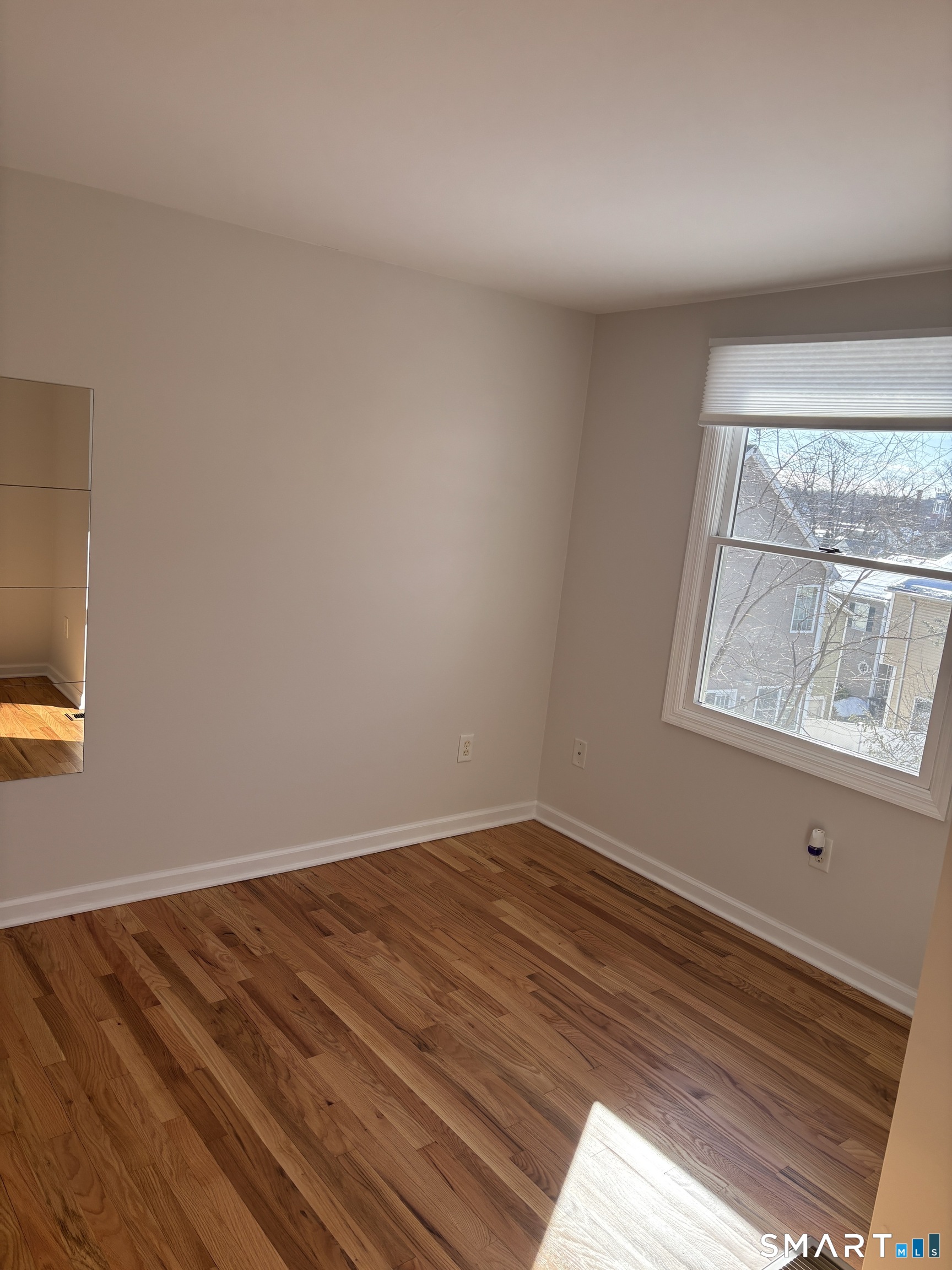 98 Ridgewood Avenue, Unit COTTAGE Stamford, CT 06907 - Photo 7 of 10 a view of a room with wooden floor and natural light