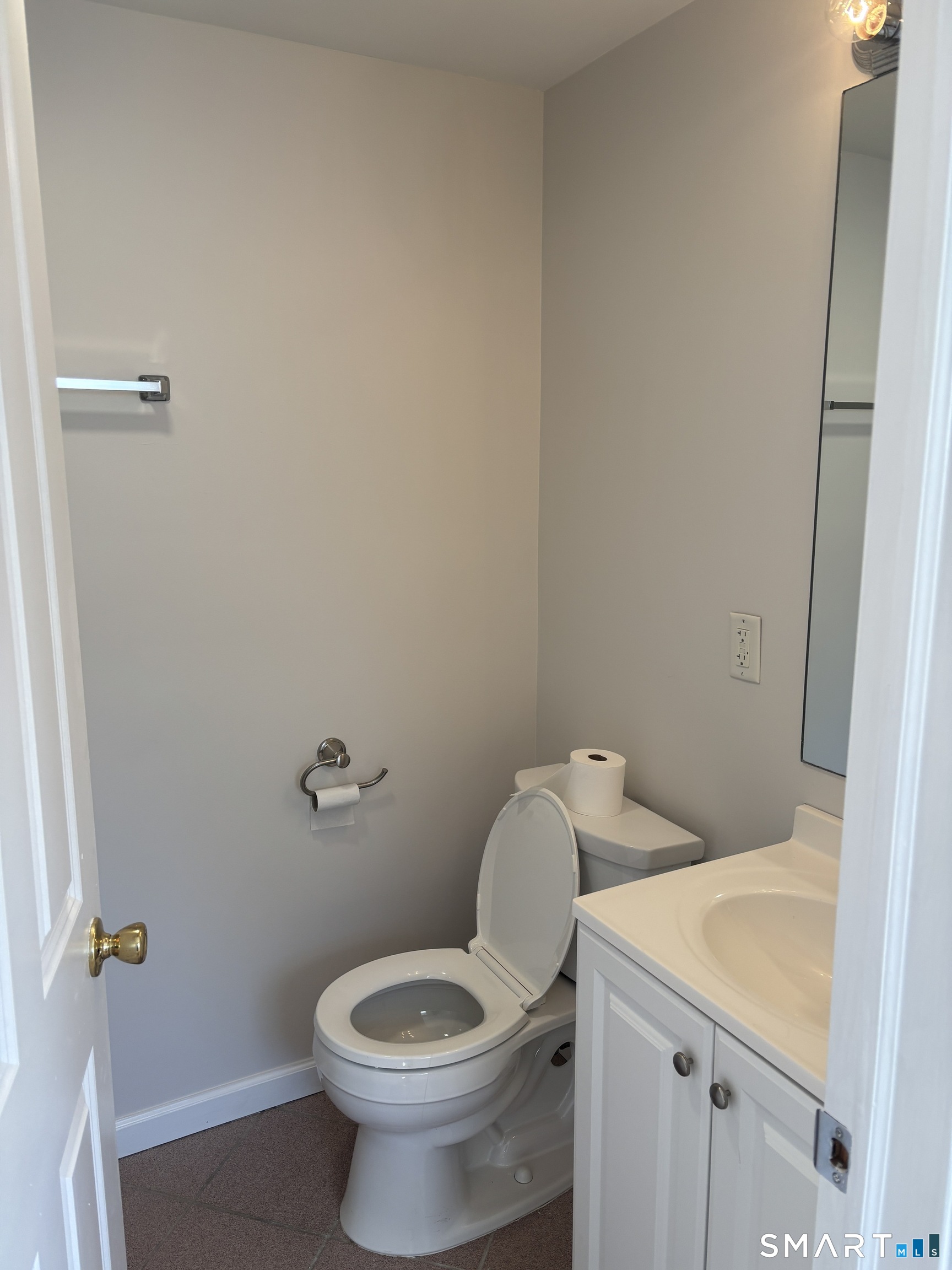 98 Ridgewood Avenue, Unit COTTAGE Stamford, CT 06907 - Photo 9 of 10 a white toilet sitting next to a bathroom sink