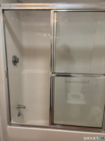 a bathroom with a glass shower door