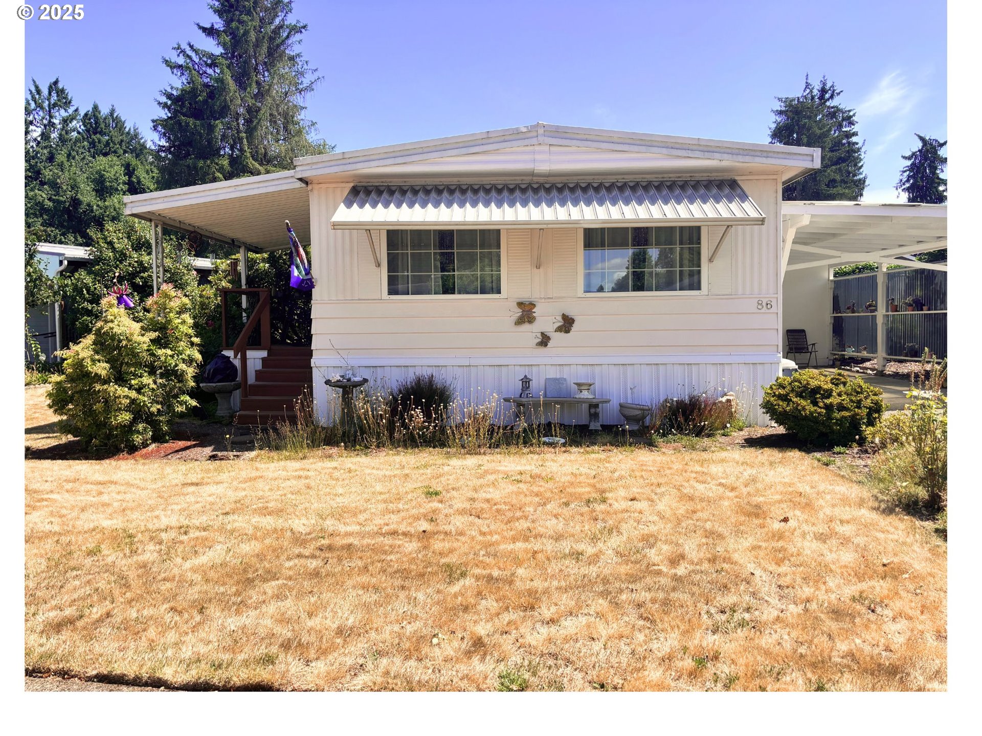 1125 58th Street, Unit 86 Springfield, OR 97478 - Photo 2 of 44 a front view of a house with a yard