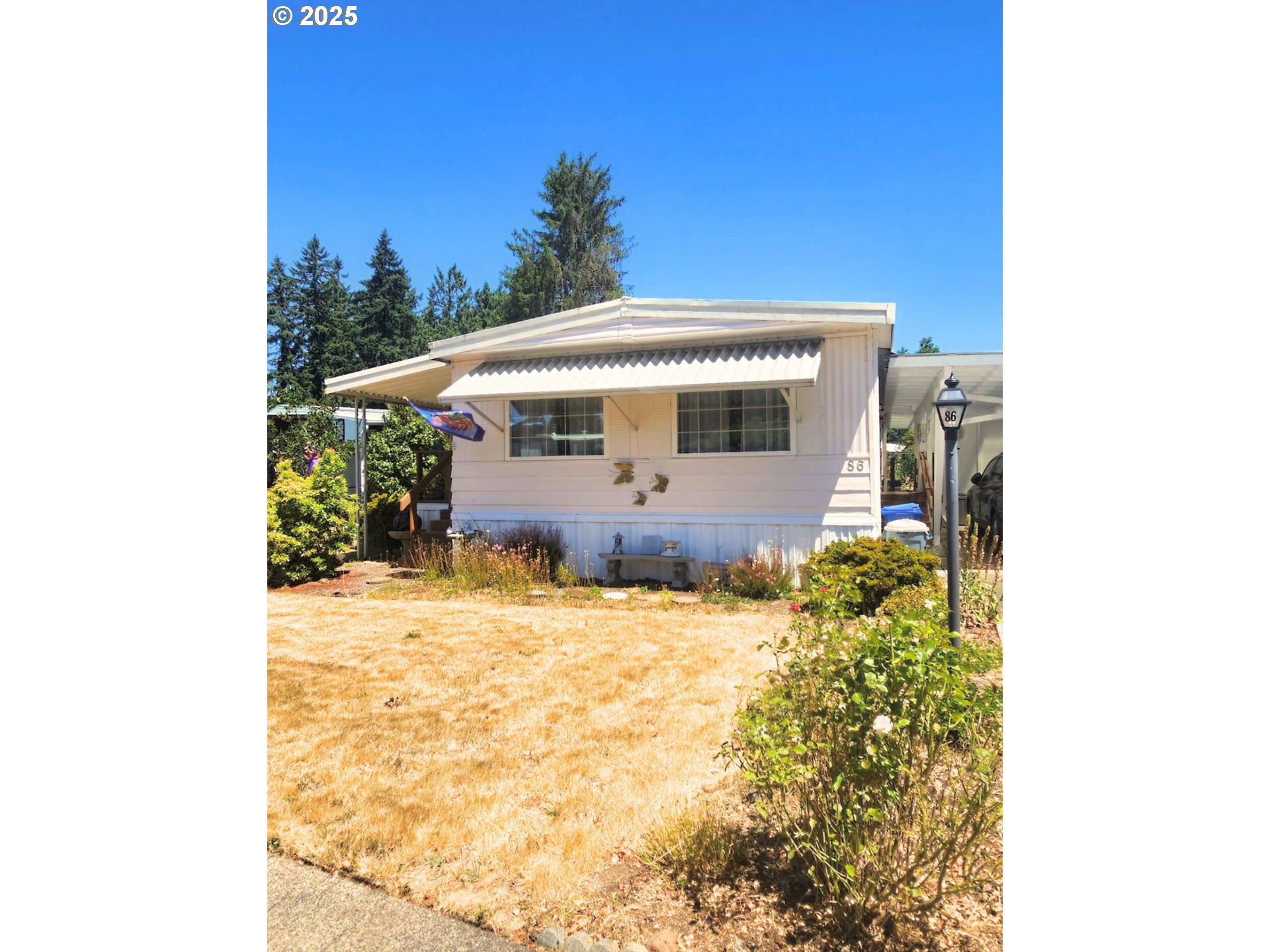 1125 58th Street, Unit 86 Springfield, OR 97478 - Photo 4 of 44 a front view of a house with a yard