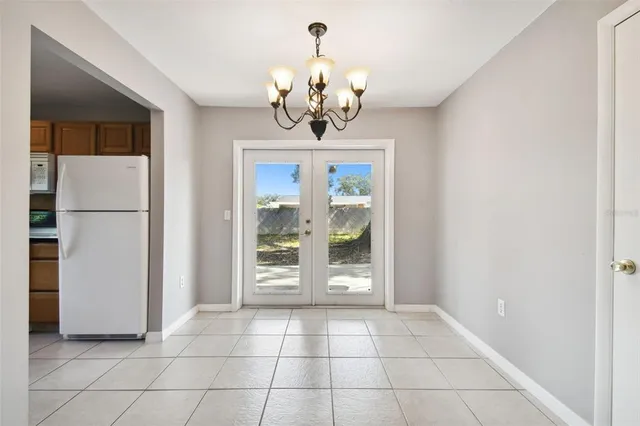 an empty room with wooden floor and a ceiling fan