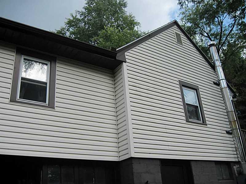 2515 Ridge Rd Extension Economy, PA 15005 - Photo 15 of 18 Exterior Back. Newer vinyl siding. Garage entrance is located in the back of the house. Wood burner stove is vented in the rear of the home, also.