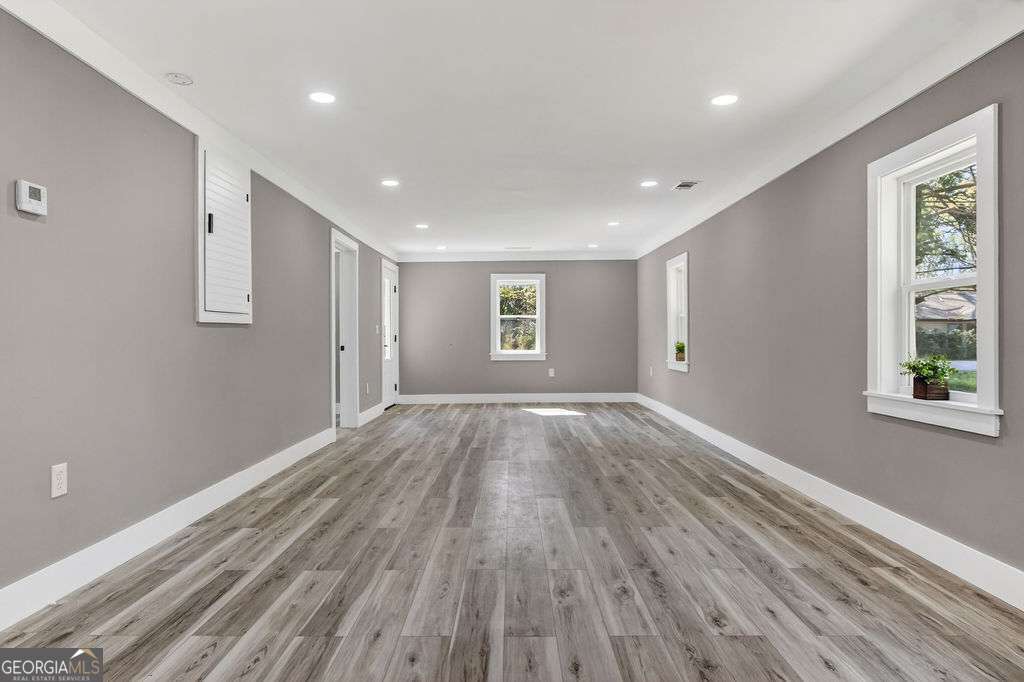 206 Walker Drive Monroe, GA 30655 - Photo 14 of 32 a view of an empty room with wooden floor and a window