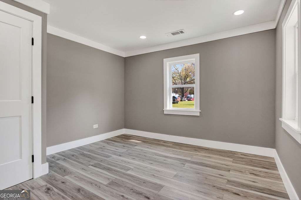 206 Walker Drive Monroe, GA 30655 - Photo 15 of 32 a view of room with wooden floor and window