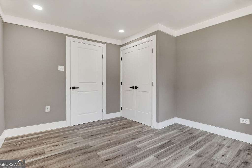 206 Walker Drive Monroe, GA 30655 - Photo 16 of 32 a view of room with wooden floor and bathroom