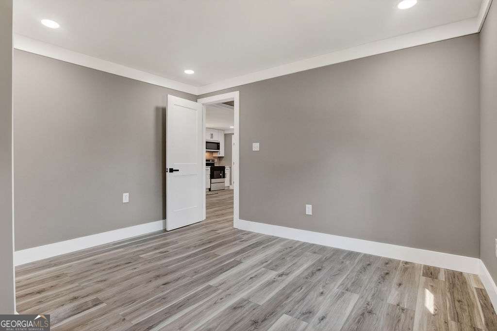206 Walker Drive Monroe, GA 30655 - Photo 17 of 32 a view of an empty room with wooden floor