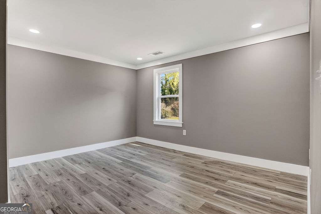206 Walker Drive Monroe, GA 30655 - Photo 21 of 32 a view of room with window and hardwood floor
