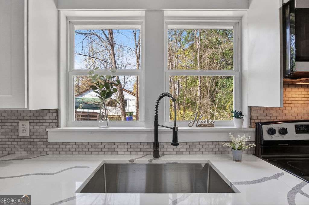 206 Walker Drive Monroe, GA 30655 - Photo 9 of 32 a kitchen with a sink a counter top space and a window
