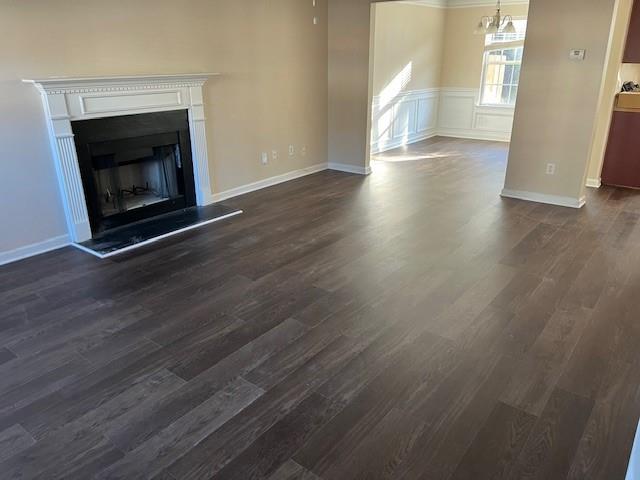 303 Millstone Drive Hampton, GA 30228 - Photo 3 of 16 a view of an empty room with wooden floor fireplace and a window