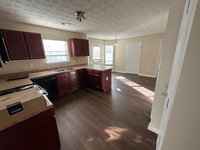 303 Millstone Drive Hampton, GA 30228 - Photo 6 of 16 a large kitchen with granite countertop a stove a sink dishwasher and a oven with wooden floor