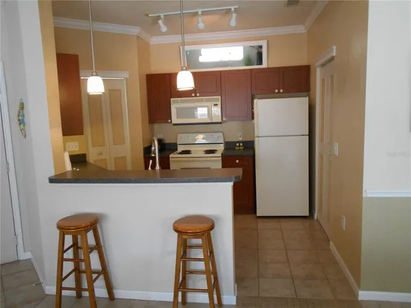 a kitchen with stainless steel appliances a refrigerator and a stove top oven