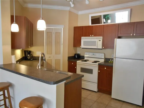 a kitchen with a sink a stove and refrigerator