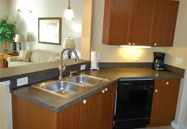 a kitchen with a sink cabinets and a window