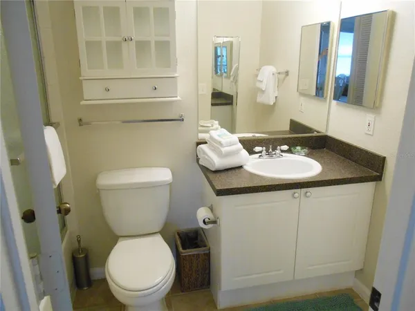 a white toilet sitting next to a bathroom sink