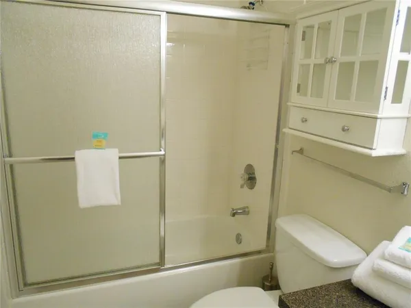a bathroom with a shower and toilet
