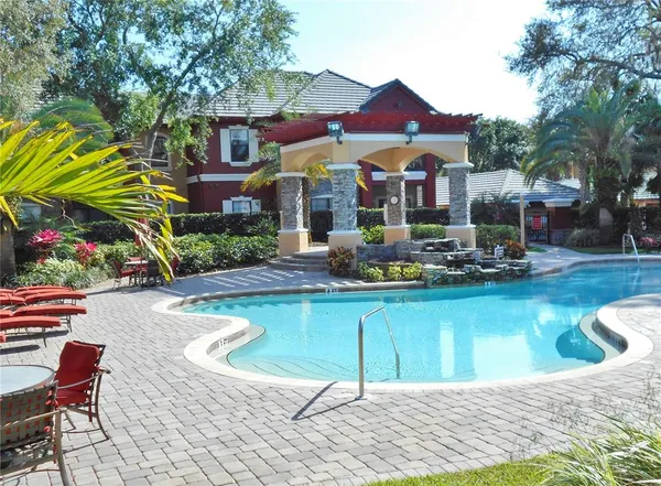 a view of swimming pool with outdoor seating and a potted plants