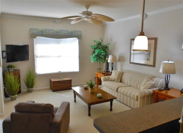 a living room with furniture a window and a flat screen tv