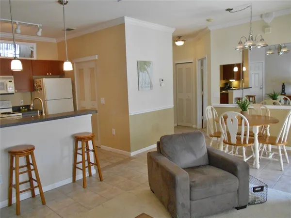 a living room with furniture and a chandelier