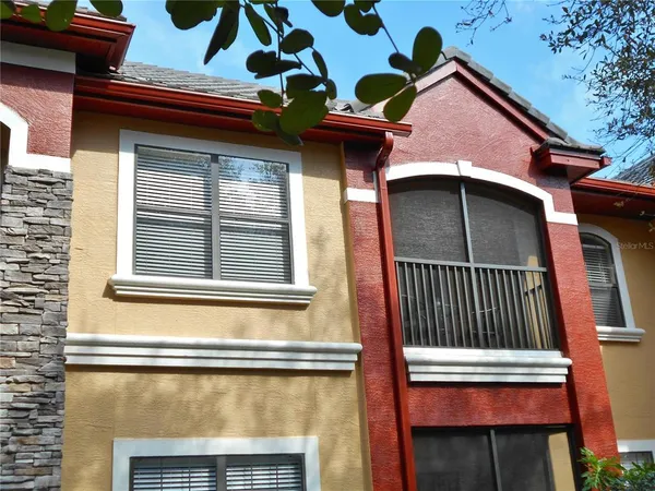 a front view of a house with a garden and plants