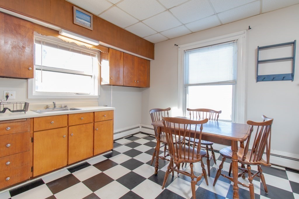 247 Rock Street Fall River, MA 02720 - Photo 15 of 30 a view of a kitchen with a table and chairs