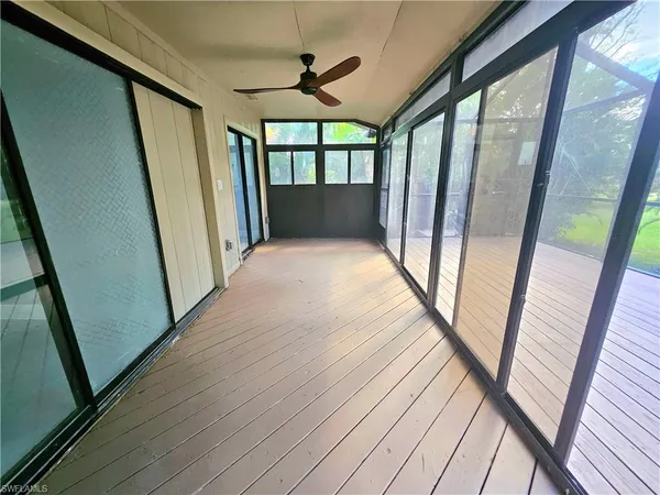 a view of hallway with wooden floor