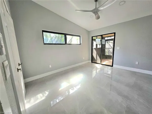 a bathroom with a granite countertop sink a toilet and shower