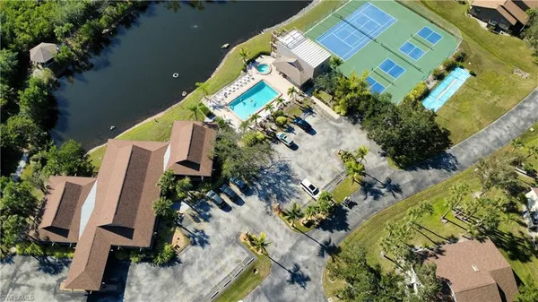 an aerial view of a house with a yard and covered with swimming pool