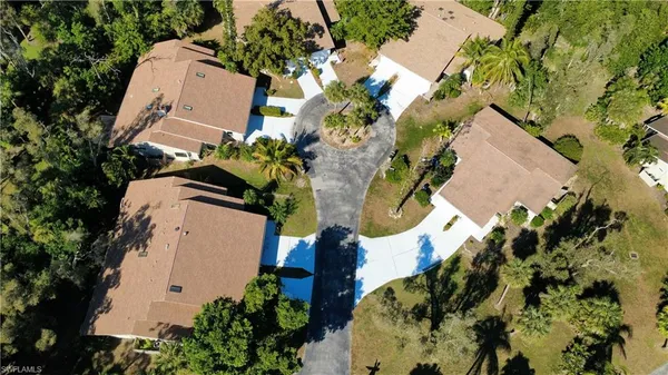an aerial view of a house with swimming pool garden and patio