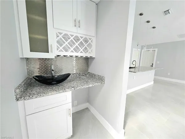 a kitchen with granite countertop a sink and a stove