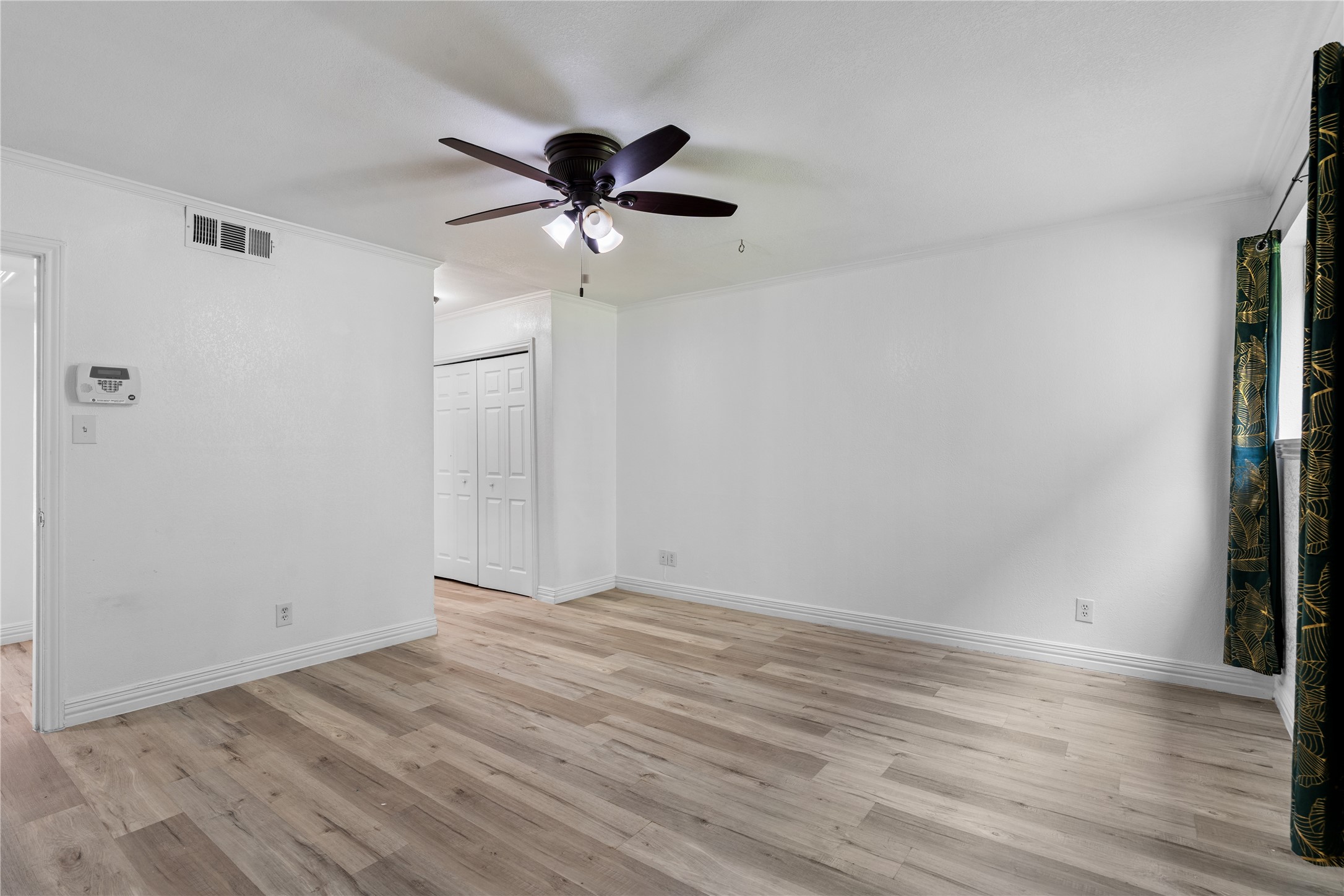 6303 Crab Orchard Road, Unit 3 Houston, TX 77057 - Photo 17 of 30 Every detail in this bedroom has been curated for comfort, from the designer baseboards to the seamless flooring that feels cool and clean underfoot. The proximity to the dual-closet entry ensures your private space remains clutter-free.